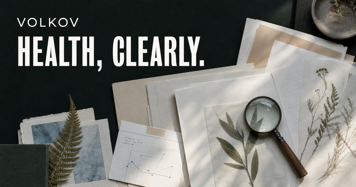 Editorial research desk with botanical materials, notes and a magnifying glass